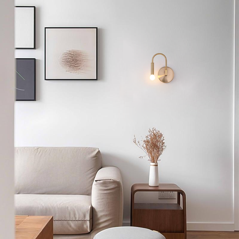 Wall Sconce with Curved Metal Arm and Rotating Exposed Bulb Holder