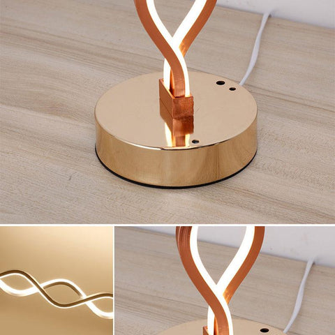 Sculptural Gold LED Table Lamp with Twisted Loop Design and Integrated Lighting