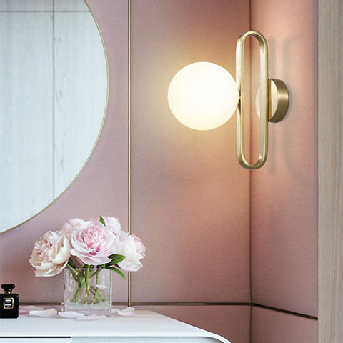 Wall Sconce with Frosted Glass Globe and Brushed Metal Loop Frame