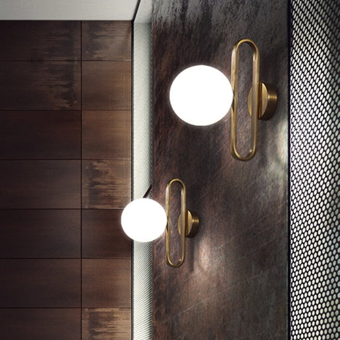 Wall Sconce with Frosted Glass Globe and Brushed Metal Loop Frame